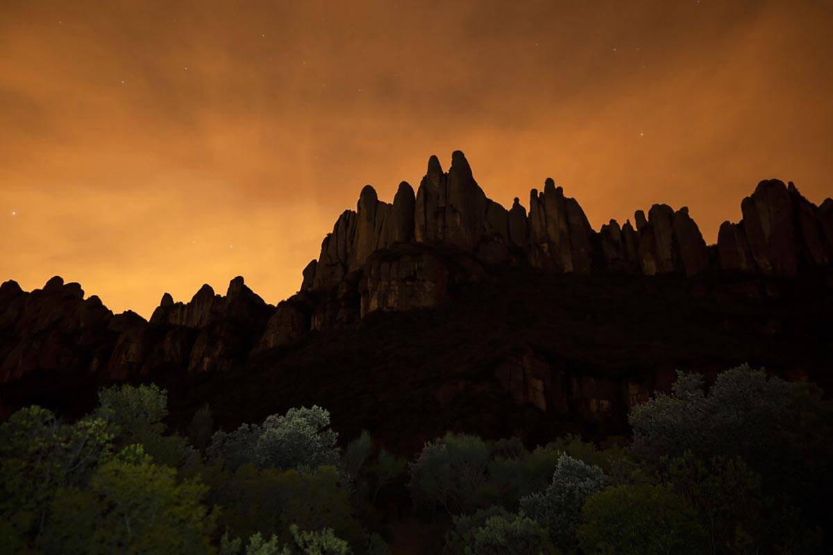 The Montserrat mountain range outside of Barcelona stands as the sun sets during the lockdown t ...