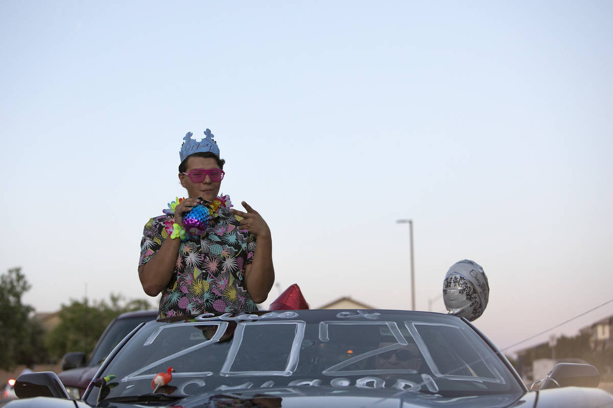 Tony Mesias, a graduating senior, drives through his school's makeshift senior night at Coronad ...