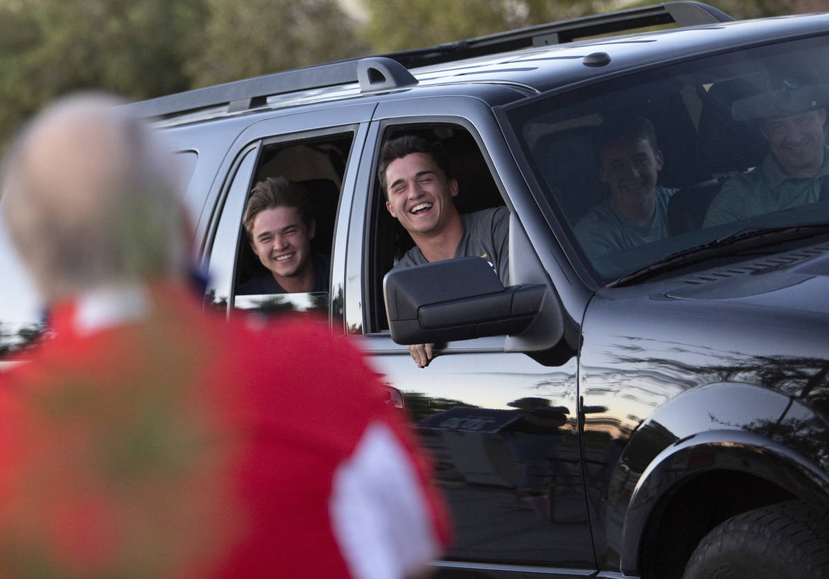Senior Wilson Scow, right, and his little brother Sam Scow cheer as they take part in a drive-t ...
