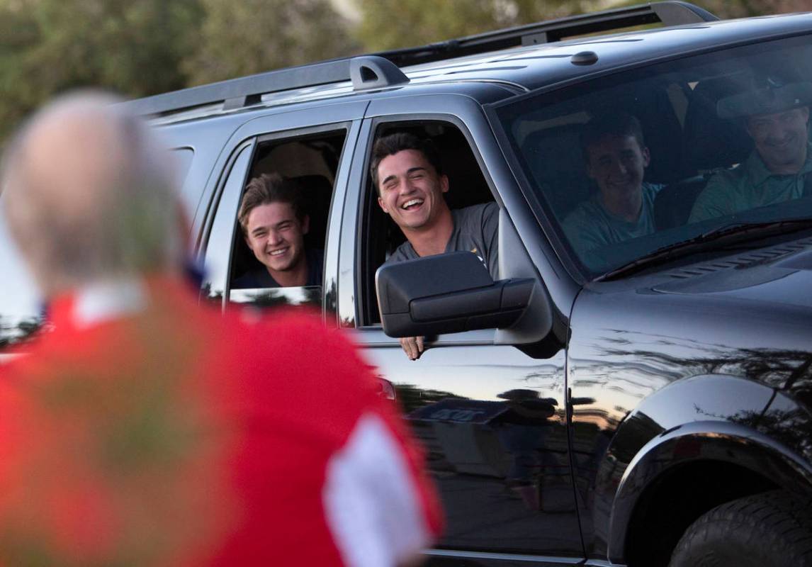 Senior Wilson Scow, right, and his little brother Sam Scow cheer as they take part in a drive-t ...