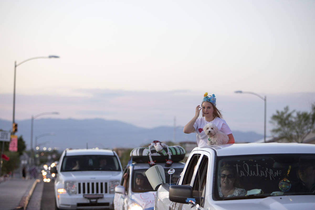 One senior wipes her tears during a drive-through parade to honor the class of 2020 at Coronado ...