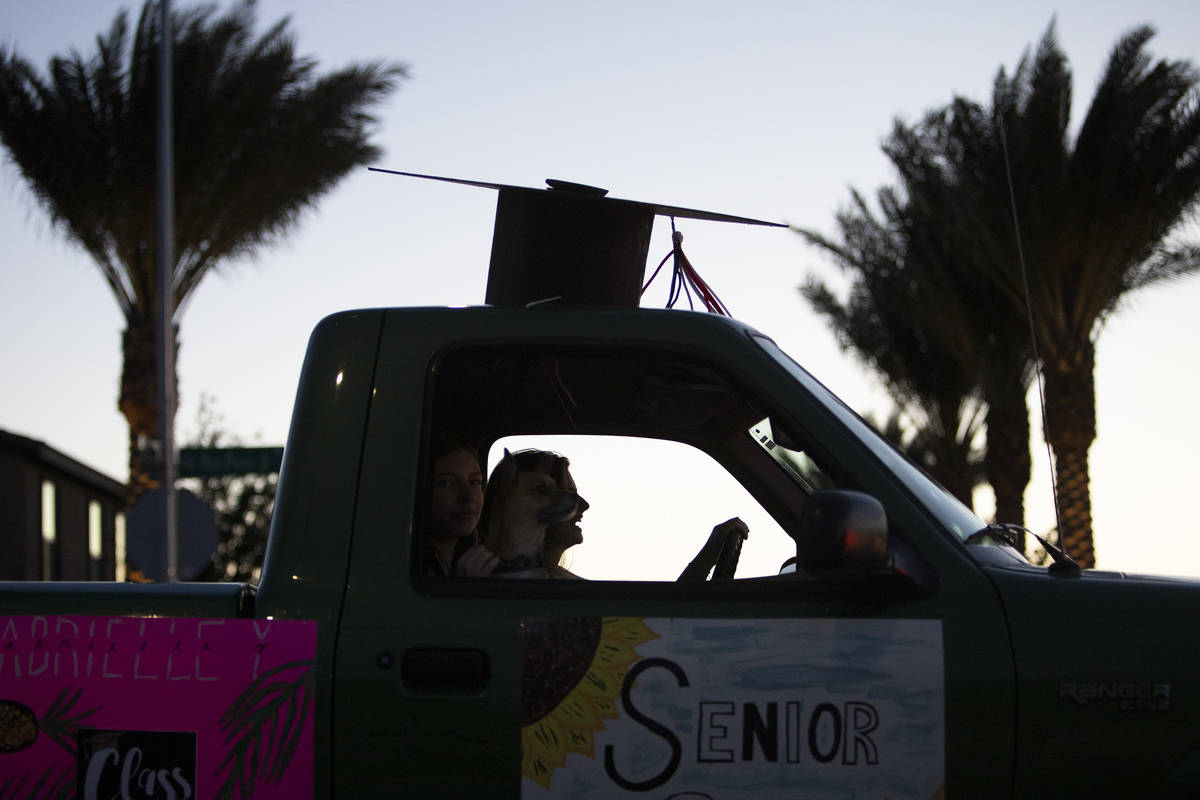 The sun goes down behind a drive-through parade for senior night at Coronado High School on Fri ...