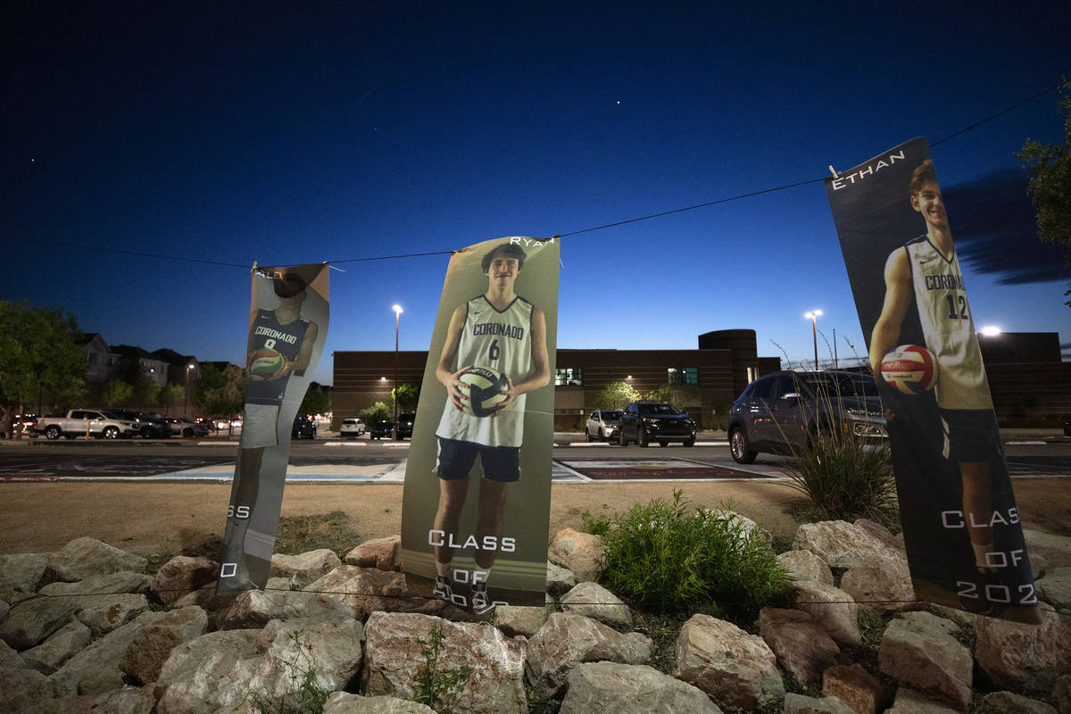 Photos of members of Coronado's basketball team seniors hang beside a drive-through parade for ...