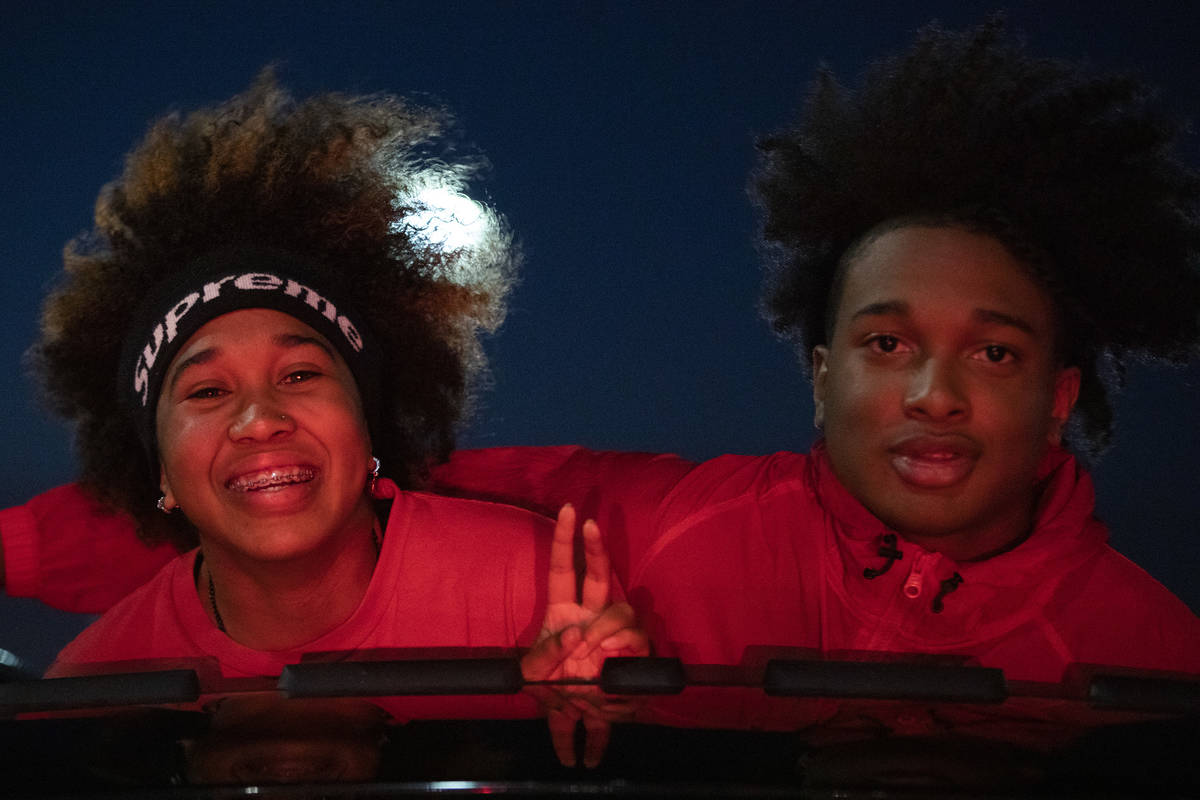 Senior Sade Williams, a basketball player, and her brother Tahj Williams, drive through the sen ...