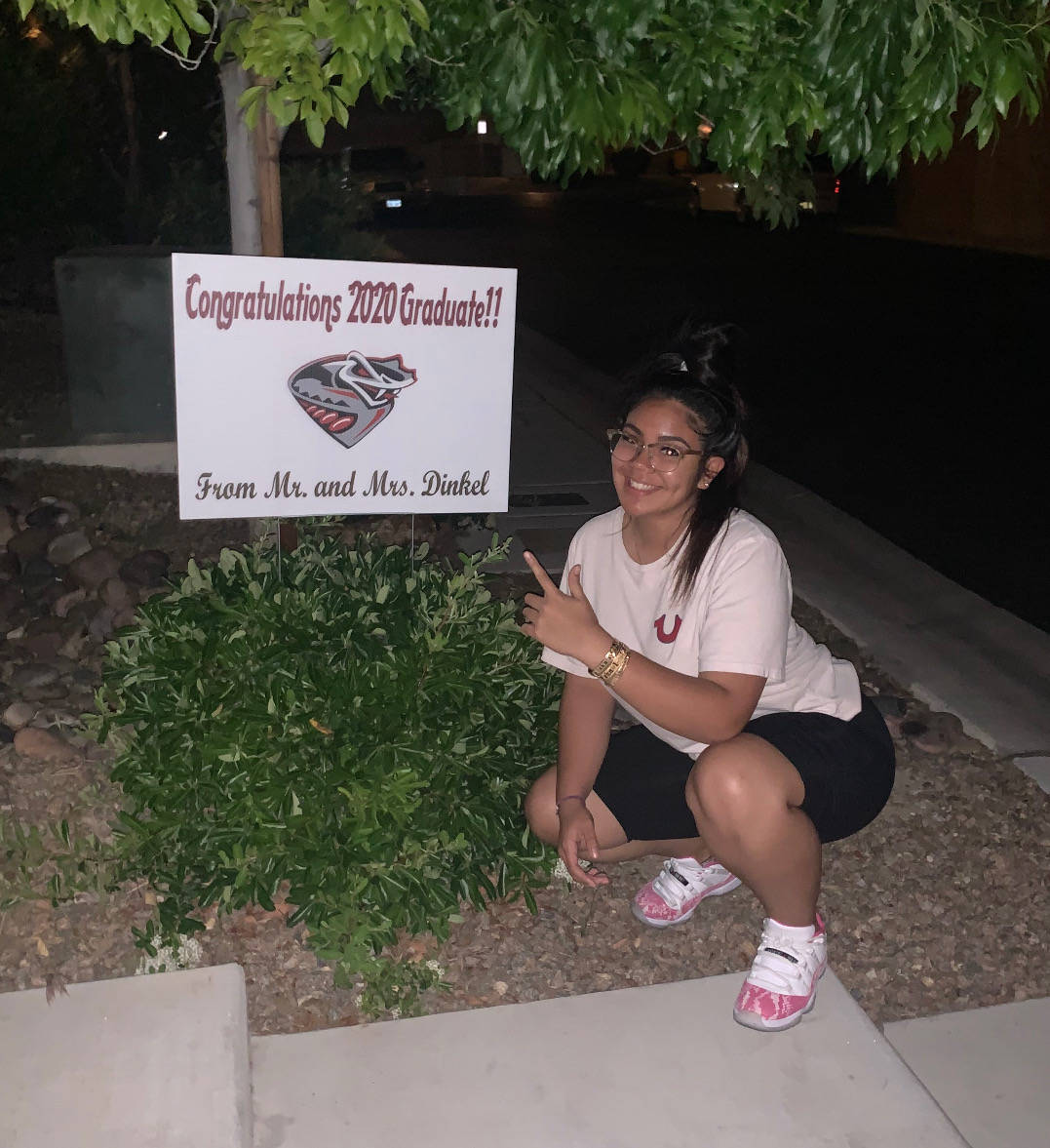 Jazmyne Compehos, a softball player and bowler at Desert Oasis, poses with a sign given to her ...