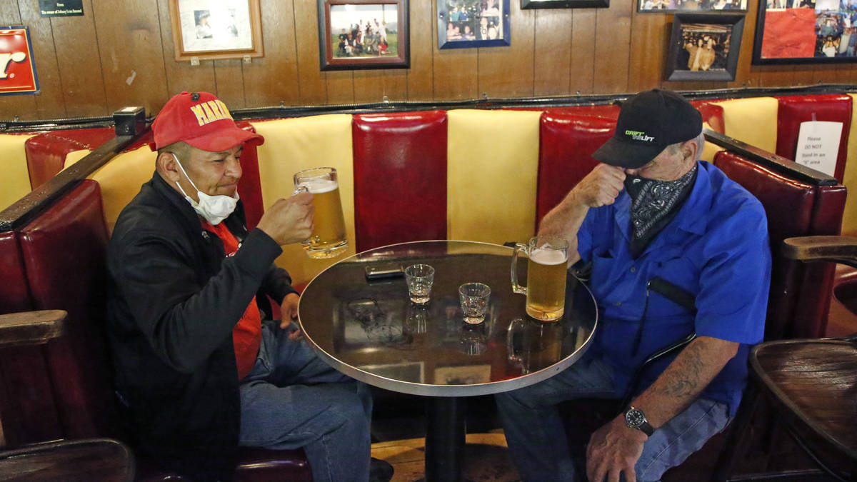 Cheers to You patrons Clifford Pesheep, left, and Mark Patterson drink beer at Cheers to You ba ...