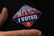A voter shows off his "I Voted" sticker after casting his ballot in 2018. (Bizuayehu Tesfaye/La ...