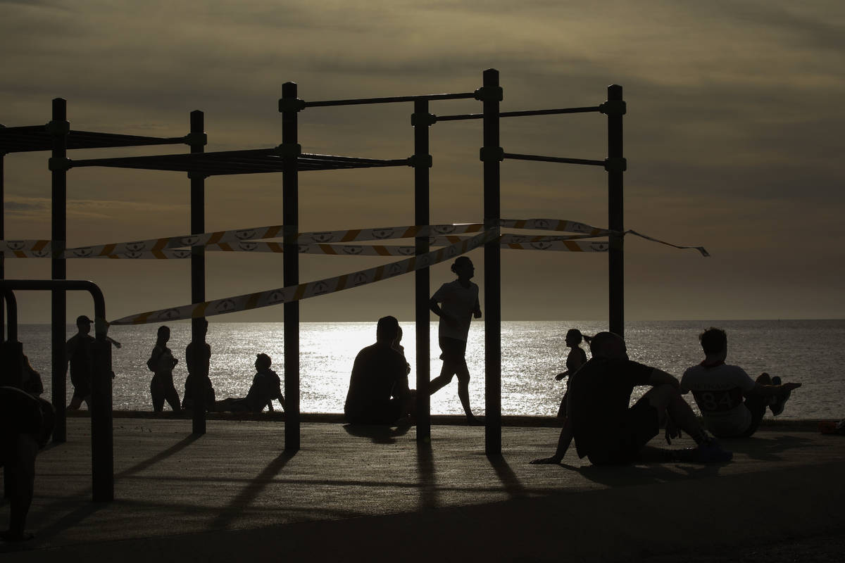 People exercises in a seafront promenade in Barcelona, Spain, Saturday, May 2, 2020. Spaniards ...