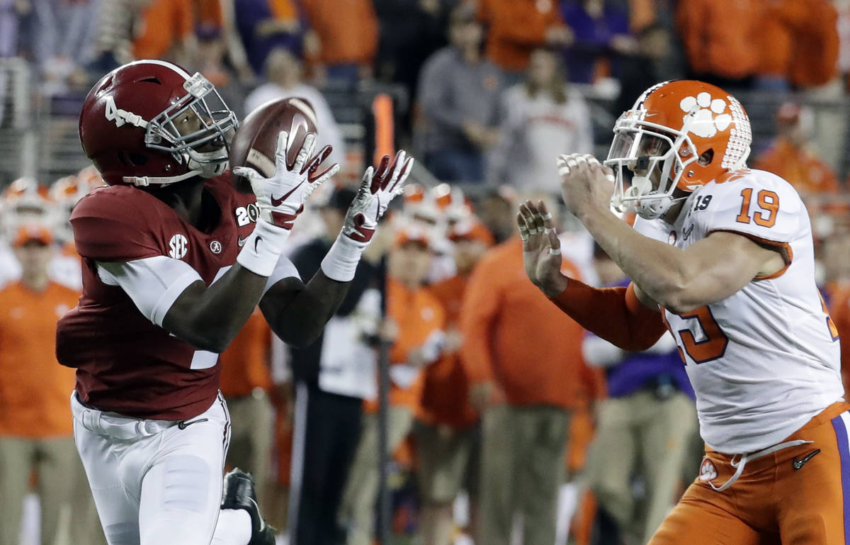 Alabama's Jerry Jeudy catches a touchdown pass in front of Clemson's Tanner Muse during the fir ...