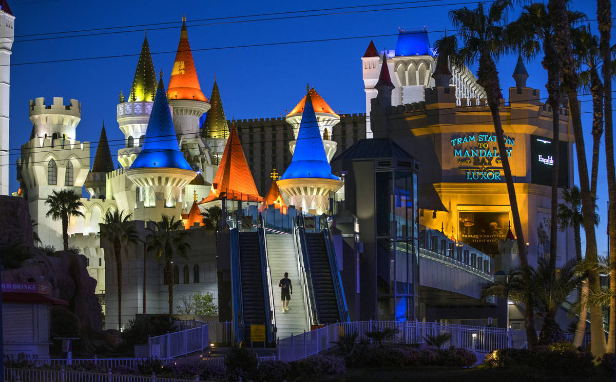 A pedestrian walks down from the bridge across from the Excalibur at Las Vegas Boulevard on the ...