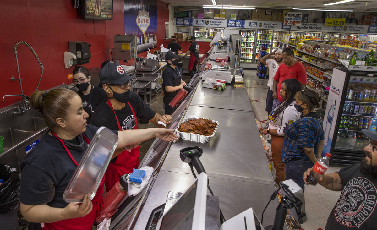 Sandy Nuno, left, and Javier Ramirez ready a meat order for a customer at the Los Primos Meat M ...