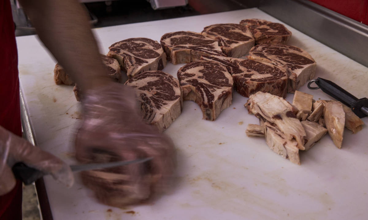 Owner Oscar Nuno Sr., trims up beef ribeye at the Los Primos Meat Market on Sunday, May 3, 2020 ...