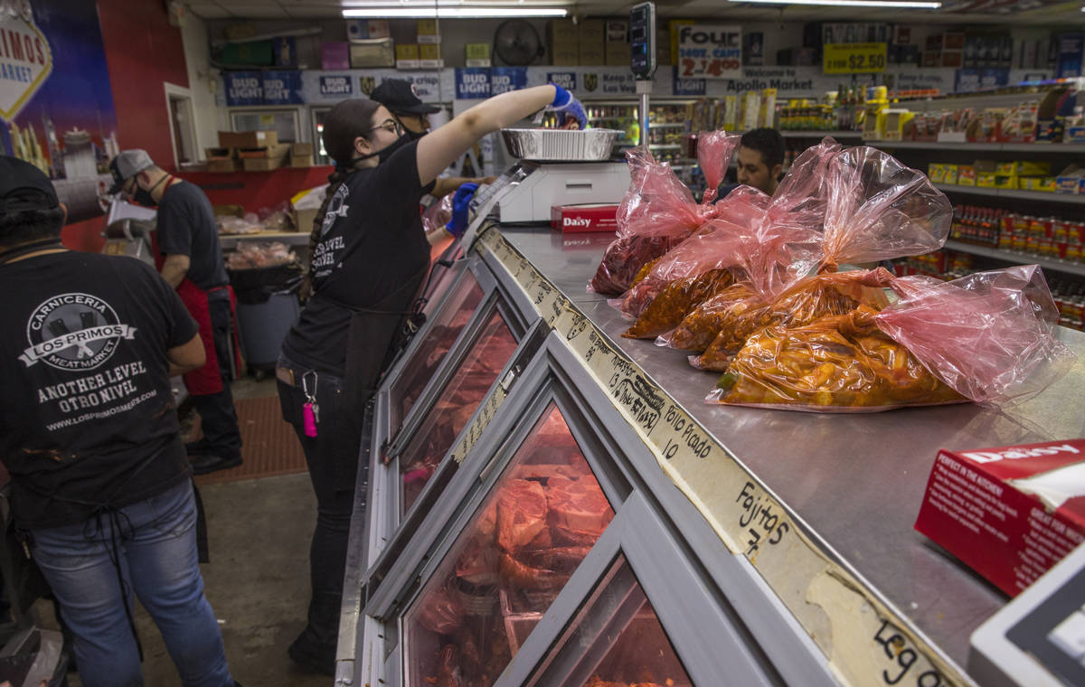 Jessica Nuno prepares an online order for a customer at the Los Primos Meat Market on Sunday, M ...