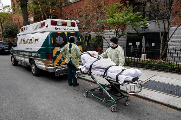 FILE- In this April 17, 2020 file photo, a patient is wheeled out of Cobble Hill Health Center ...
