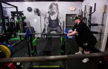 Paul Minor grabs weights at The Lift Factory in Las Vegas on Thursday, Feb. 27, 2020. (Chase St ...