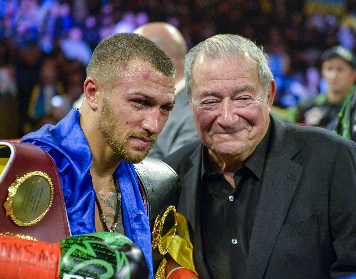 Vasiliy Lomachenko poses with promoter Bob Arum after defeating Jose Pedraza in the WBO title l ...