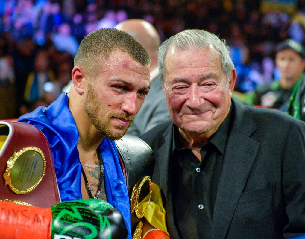 Vasiliy Lomachenko poses with promoter Bob Arum after defeating Jose Pedraza in the WBO title l ...