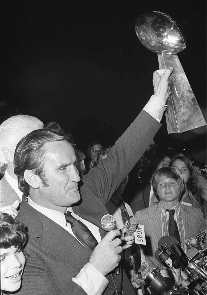 Miami Dolphins coach Don Shula waves the Super Bowl trophy for fans as they arrive in Miami aft ...