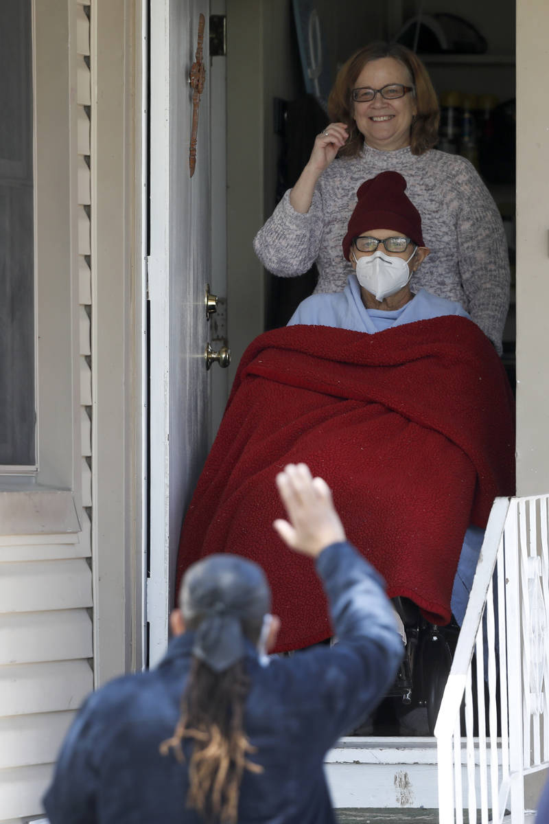 A supporter of "Cross Man" Greg Zanis, waves to Zanis and his wife Susan, while supporters pay ...