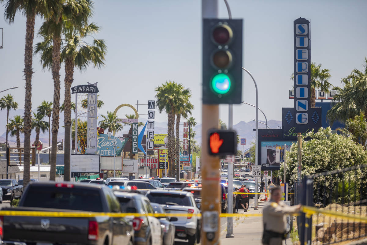 Las Vegas police investigate a downtown shooting in the 1900 block of Fremont Street in Las Veg ...