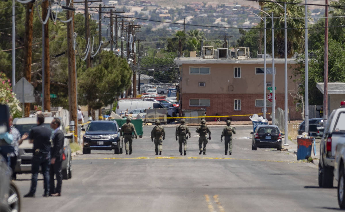 Las Vegas police investigate a downtown shooting in the 1900 block of Fremont Street in Las Veg ...