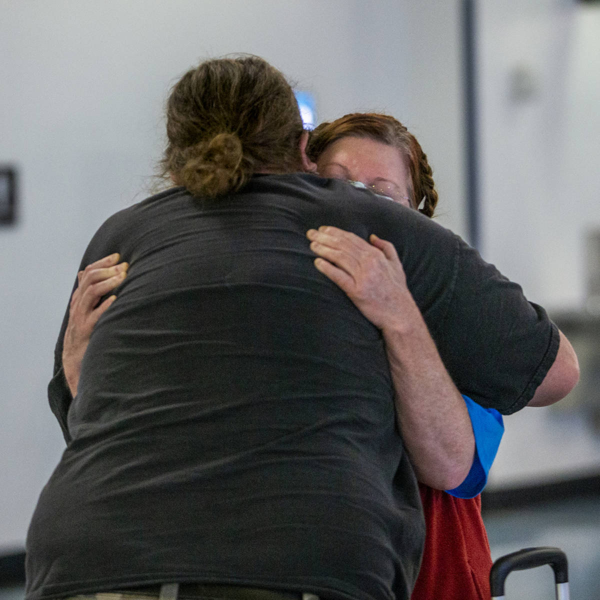Jack Yowell hugs his wife Susan as she arrives at the Terminal 1 baggage claim in McCarran Inte ...