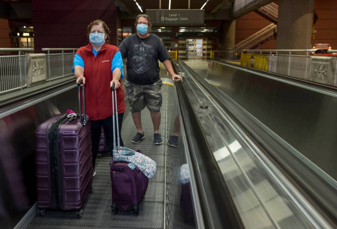 Susan Yowell and husband Jack depart the Terminal 1 baggage claim in McCarran International Air ...