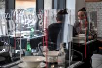 Dario Goga, left, and Neri Goga, owners of Goga Cafè restaurant in Milan, sit at a table w ...