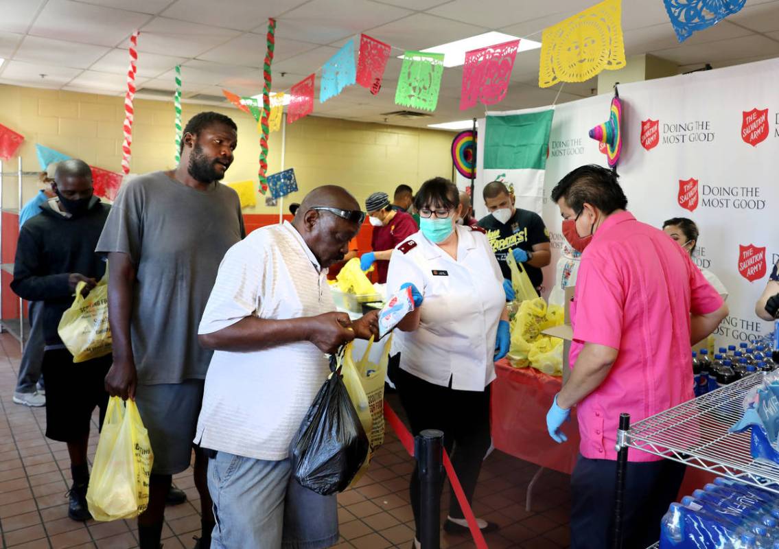 Individuals receive lunch and pandemic kits during a Cinco de Mayo celebration, provided by Viv ...