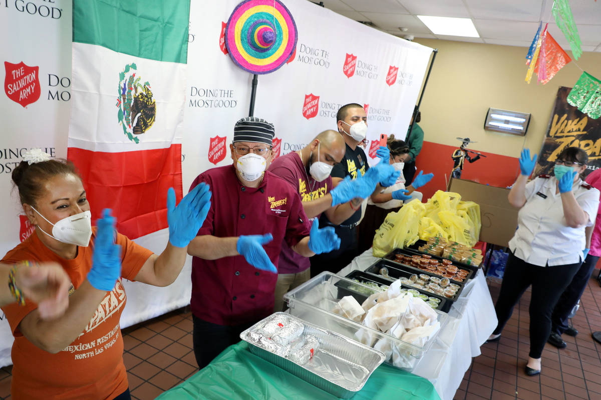 Staff from Viva Zapata's Mexican Restaurant and Cantina clap as a live mariachi band plays duri ...