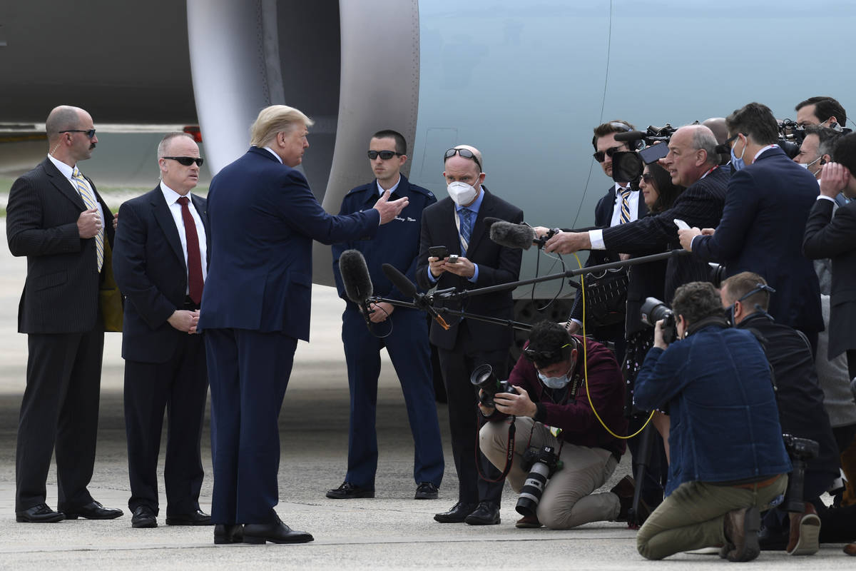 President Donald Trump talks with members of the traveling press before departing Andrews Air F ...