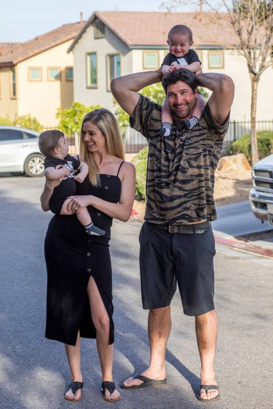 Shannon and David Belford pose for a portrait with their 9-month-old twin sons, Gavin and Garre ...