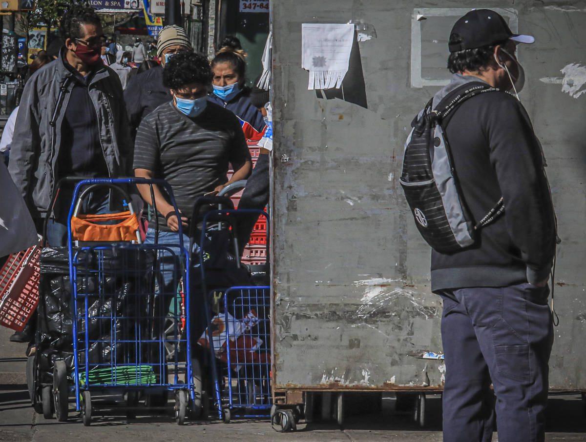 People waiting to enter a grocery store in Brooklyn's Sunset Park—a neighborhood with on ...