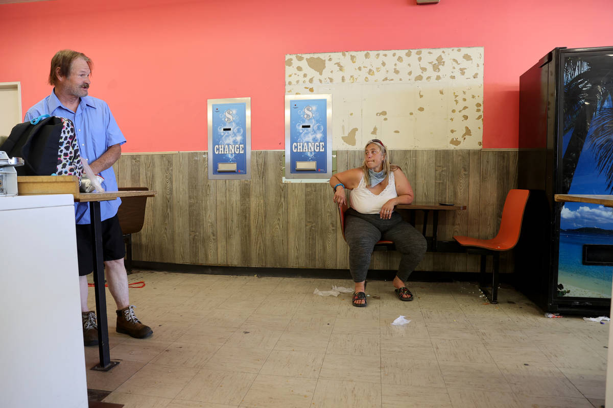 Michelle Fuller Hines talks to a Larry Shaw, 60, at Emmy's Laundromat on East Main Street in Ba ...