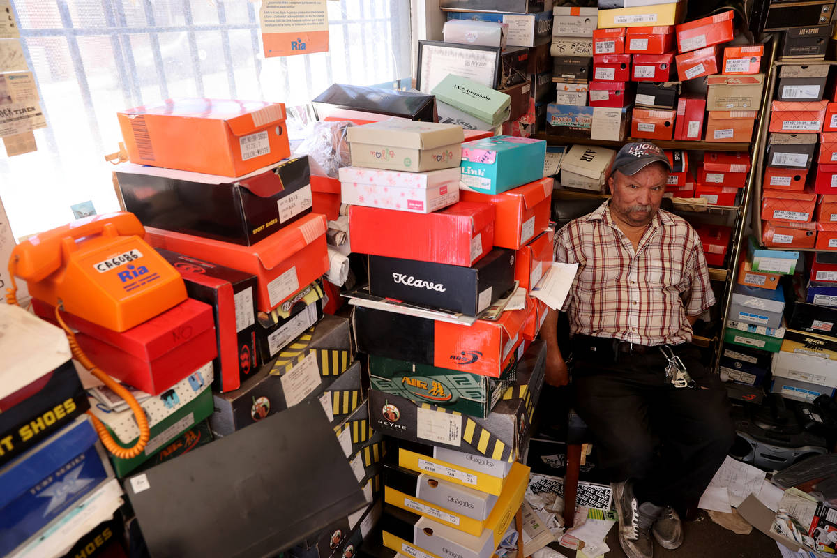 Pedro Valencia waits for customers at his shoe store on 2nd Avenue near East Main Street in Bar ...