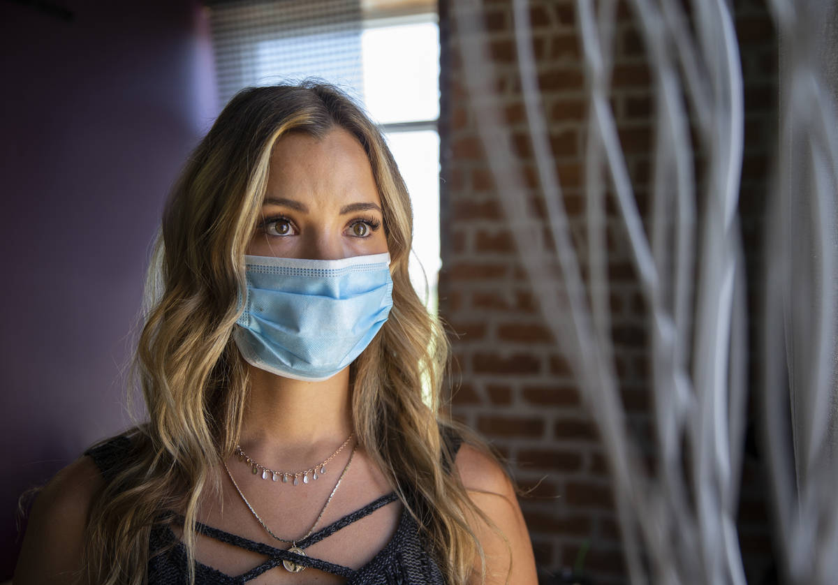 Stylist Vanessa Faylor wears a medical mask at Khroma Salon on Tuesday, May 5, 2020, in St. Geo ...