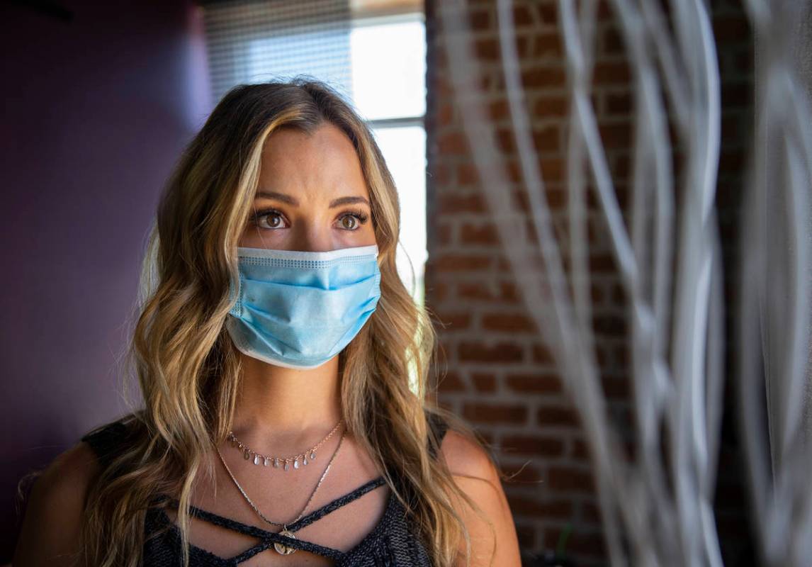 Stylist Vanessa Faylor wears a medical mask at Khroma Salon on Tuesday, May 5, 2020, in St. Geo ...