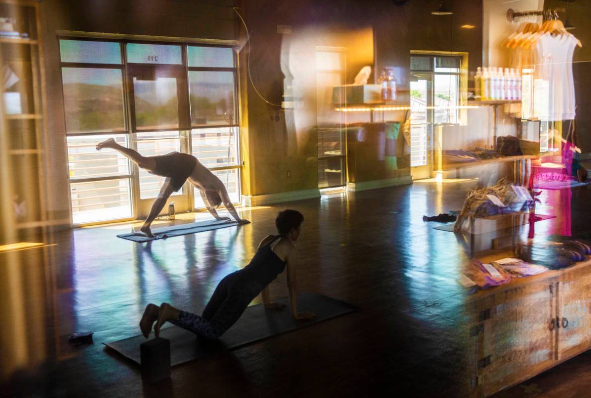 A hot flow class is taught at Be Hot yoga on Tuesday, May 5, 2020, in St. George, Utah. (Benjam ...