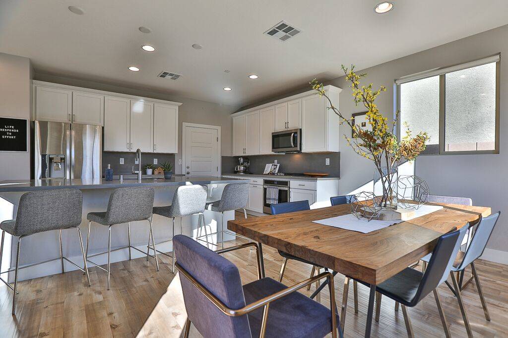 The dining area is off the kitchen had has a modern look and a grey and white palette. (Life Re ...