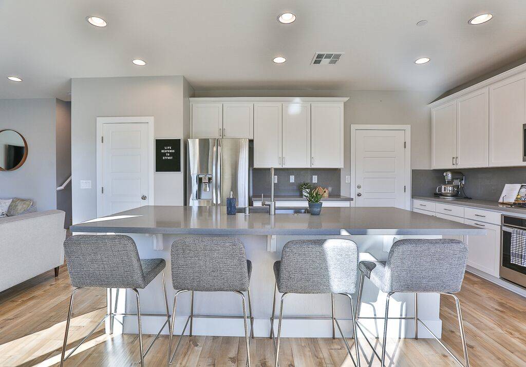 The kitchen has a large center island with plenty of seating for guests. (Life Realty)