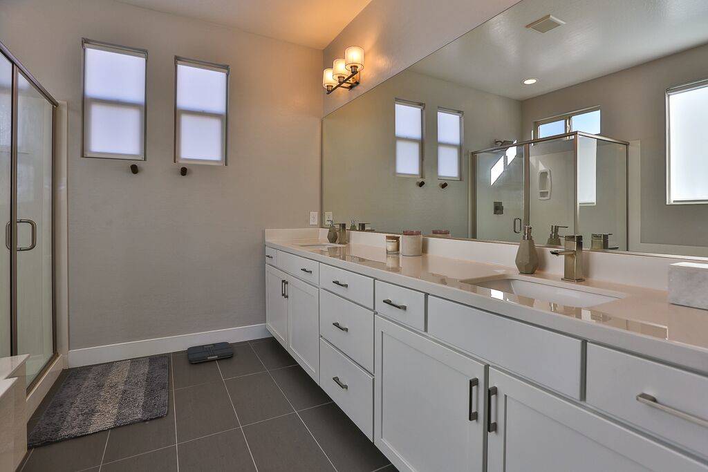 The master bath has lots of cabinet space for storage and a large shower. (Life Realty)