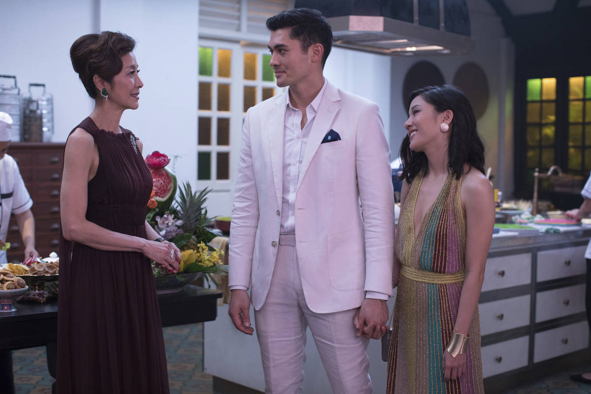 This image released by Warner Bros. Entertainment shows Michelle Yeoh, from left, Henry Golding ...