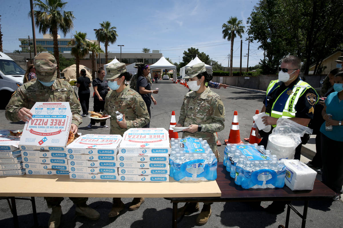 UNLV Medicine staff and Nevada National Guard members doing curbside COVID-19 testing get pizza ...