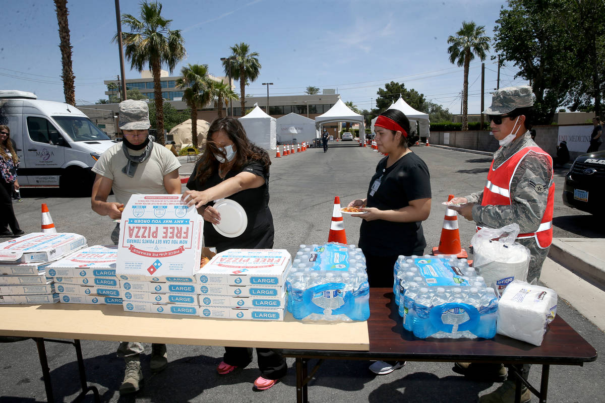 UNLV Medicine staff and Nevada National Guard members doing curbside COVID-19 testing get pizza ...