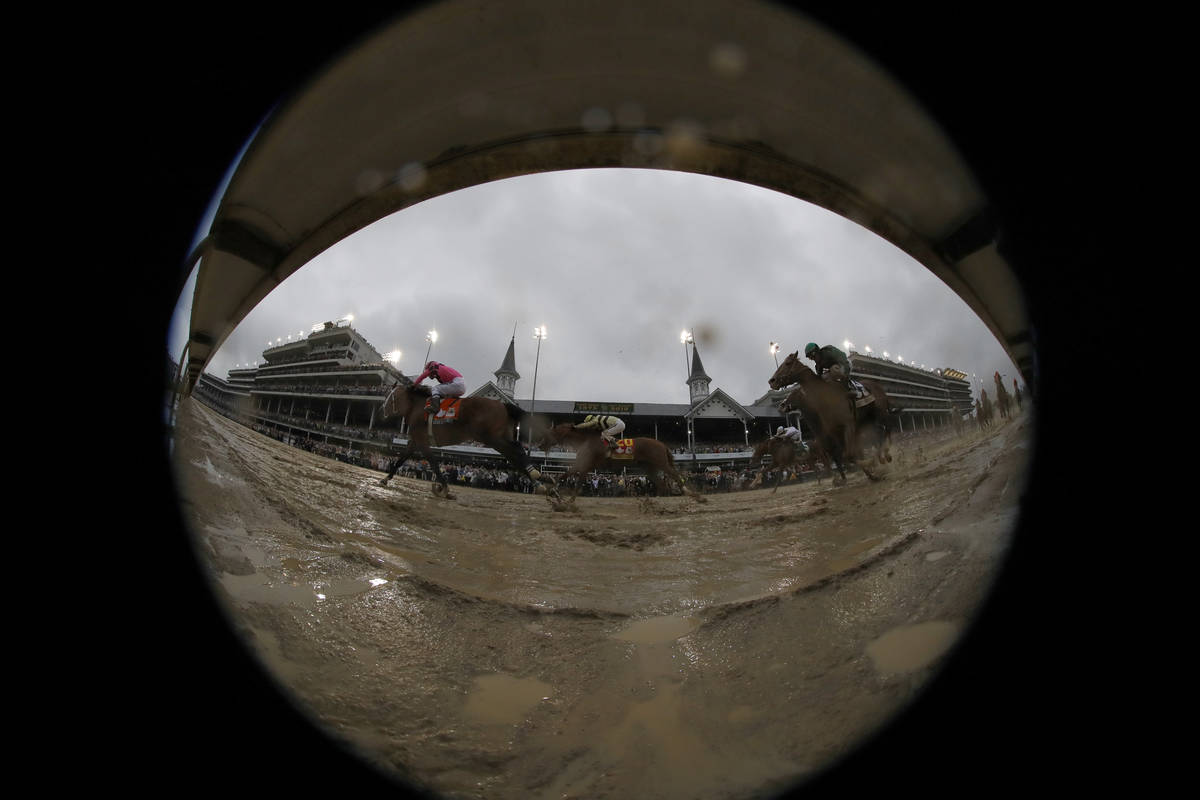 In this photo made with a fish-eye lens, Luis Saez rides Maximum Security across the finish lin ...