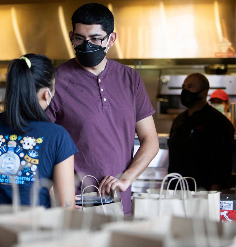 Anthony Campos talks with fellow employee Juliana Asa at Nora's Italian Cuisine on Wednesday, M ...