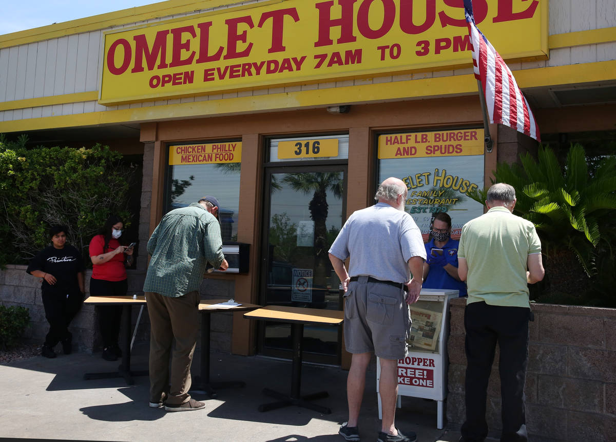 Pauline Arthur, second right, a waitress, takes orders from customers as Destiny Torres, far le ...