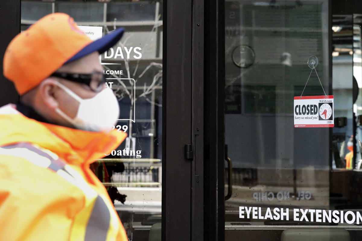 This photo shows a closed sign at Fashion Nails shop in downtown Chicago, Thursday, May 7, 2020 ...