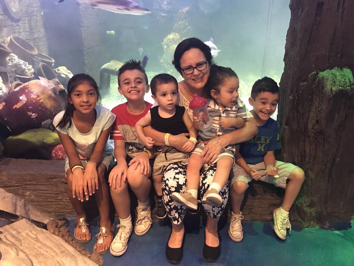 Angelica Rodriguez, 62, poses with five of her 12 grandchildren at the SeaQuest Las Vegas aquar ...