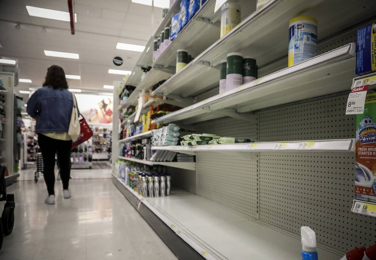 In this March 3, 2020 file photo, empty shelves for disinfectant wipes wait for restocking, as ...